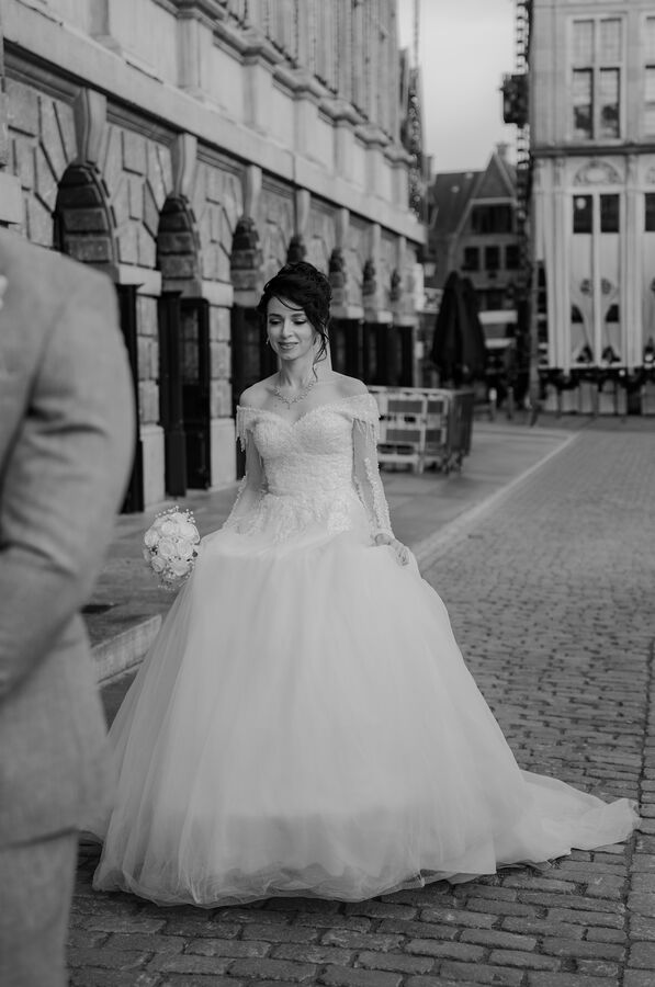 Bride and groom laughing on the Grote Markt square in Antwerp, Belgium