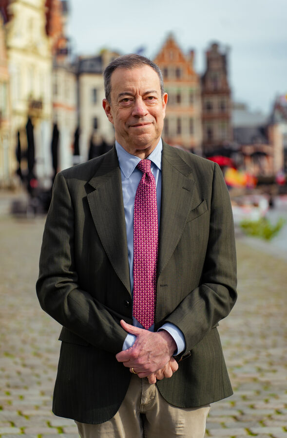 Business portrait of a man in a blazer on a historic European square